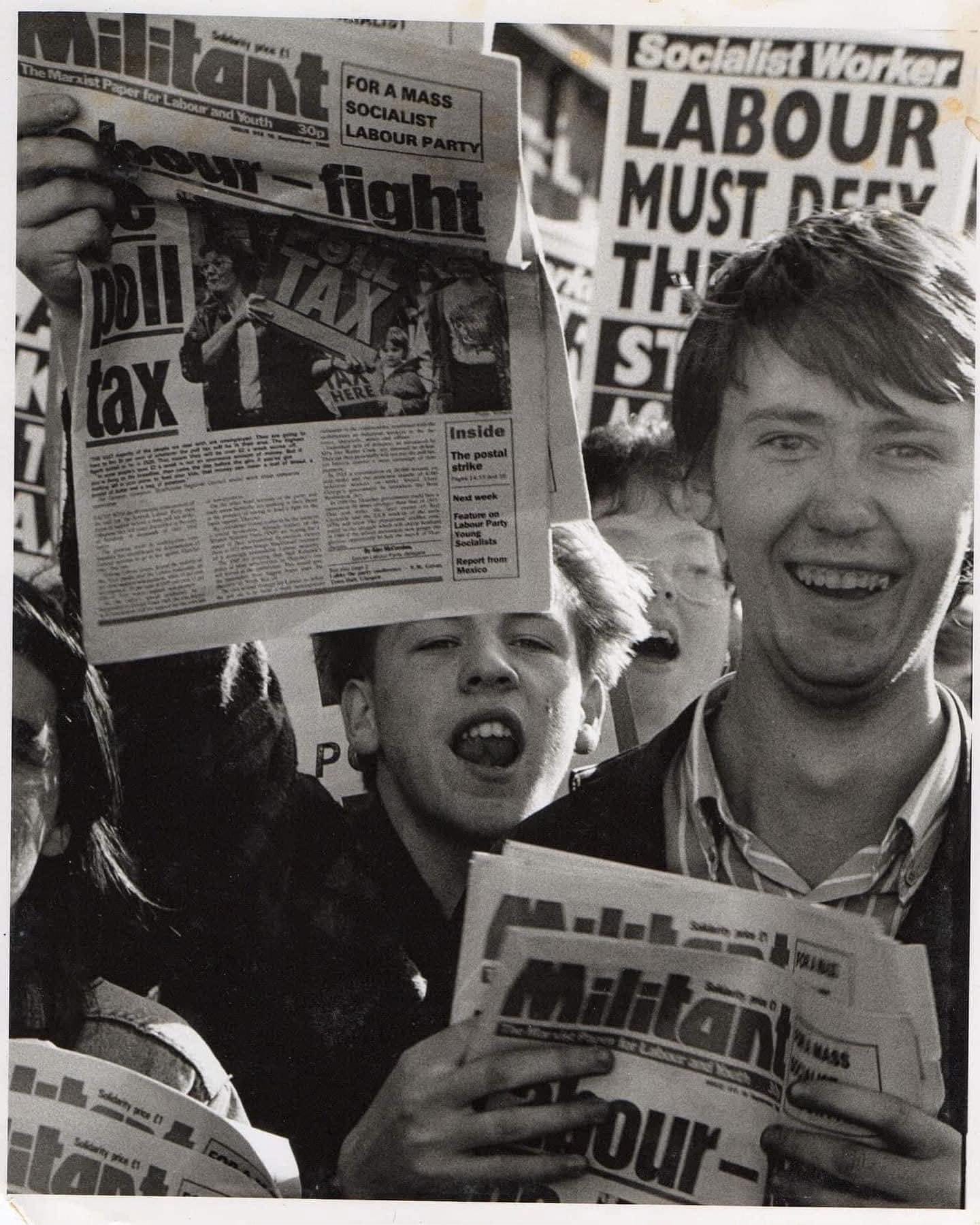 Black-and-white archive photograph of a young Gary Clark among campaigners holding newspapers