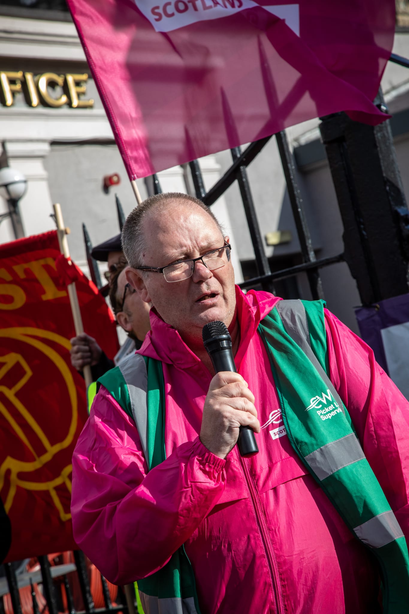 Gary Clark speaking into a microphone at a trade union rally